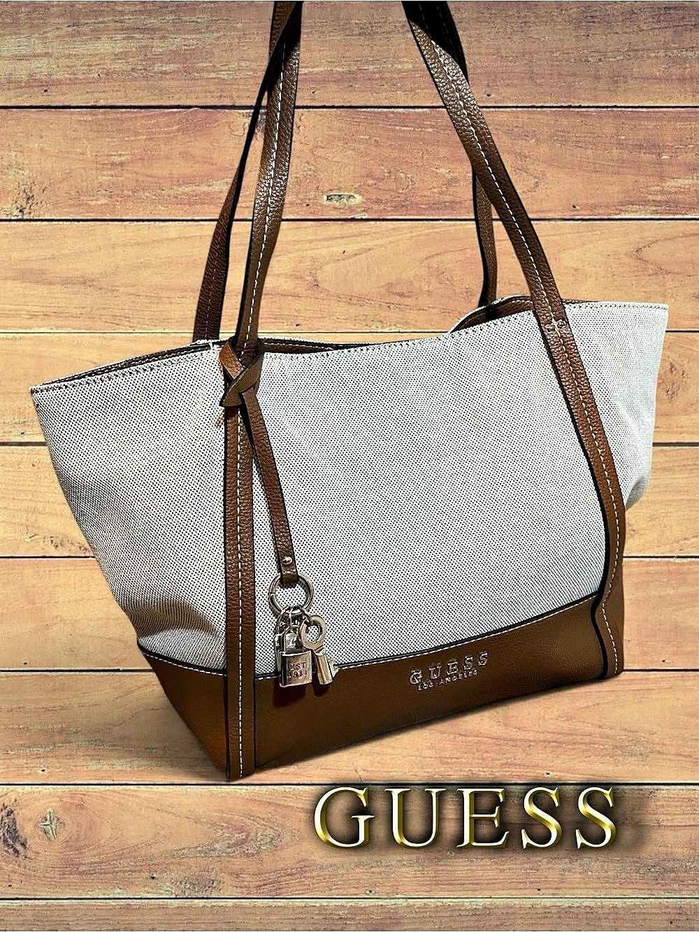 GUESS Heidi Canvas & Faux
Leather Tote Bag with Lock
Charm Trim